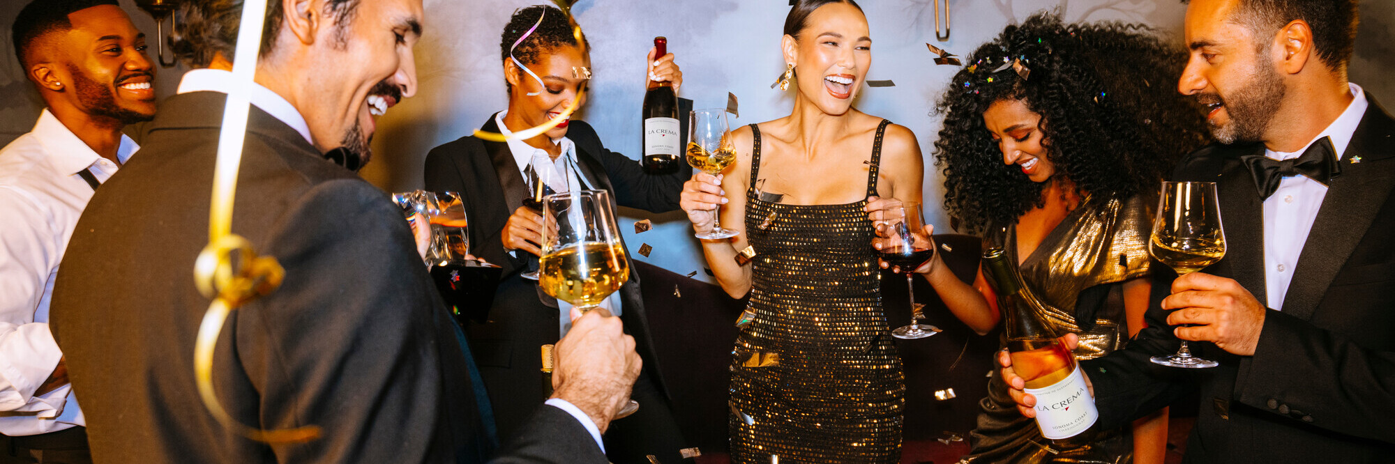 A group of friends drinking a bottles of La Crema wine